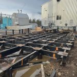 The Donald Rigging crew adds more jacks and blocks to build a sturdier base for their jack and slide on the soft, wet ground.